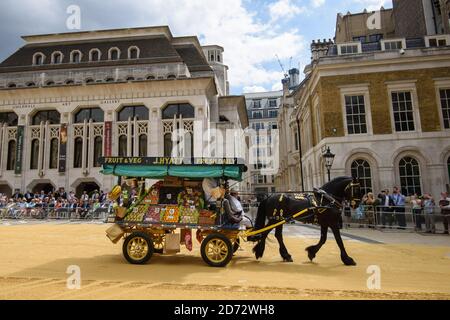 Members of the Worshipful Company of Carmen drive their historic carts and vehicles to Guildhall, in the City of London, for the annual Cart Marking Ceremony. The tradition, originating in the licensing of vehicles for hire in the 17th century, sees each vehicle branded with a letter to mark its official licensed status. Picture date: Wednesday July 18th, 2018. Photo credit should read: Matt Crossick/ EMPICS Entertainment. Stock Photo