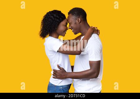 Black lovers hugging and looking at each other Stock Photo