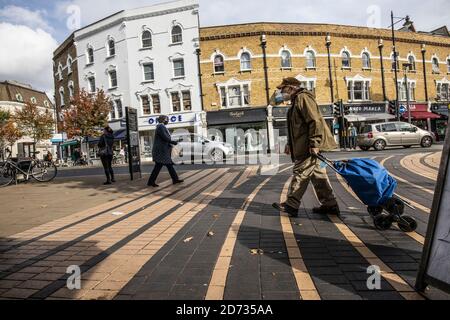 Homeless man crossing the pavement in Wimbledon town centre, Southwest London, England, UK Stock Photo