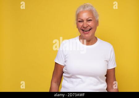 Beautiful elderly lady with a lively smile looking directly at the camera Stock Photo