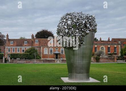 Stainless steel sculpture called When Soak Becomes Spill by artist Subodh Gupta on display in the grounds of Salisbury Cathedral, Wiltshire, UK. Stock Photo