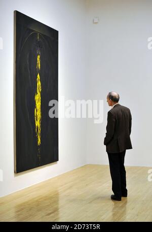 Visitors look at works by Chris Ofili on display at a new exhibition of ...