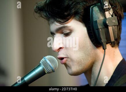 Ezra Koenig of Vampire Weekend performs live at the Absolute Radio studios in central London, as part of the Geoff Lloyd Hometime Show.  Stock Photo