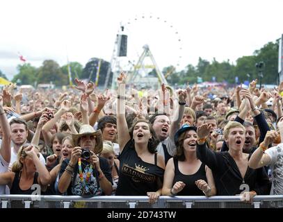 The crowd watch Madness performing on the V Stage during the Virgin Media V Festival, in Hylands Park, Chelmsford, Essex. Stock Photo