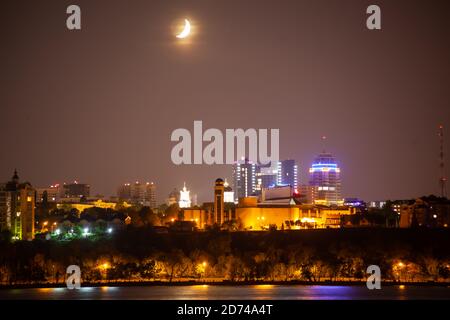 The moon shines over the night city Stock Photo