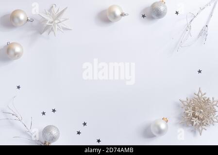 Creative white Christmas background with gift boxes and holiday shiny confetti decoration, copy space. Flat lay. Greeting postcard. Stock Photo