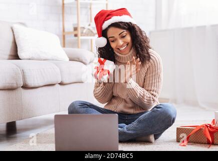 Black Woman Opening Present Box At Home Stock Photo