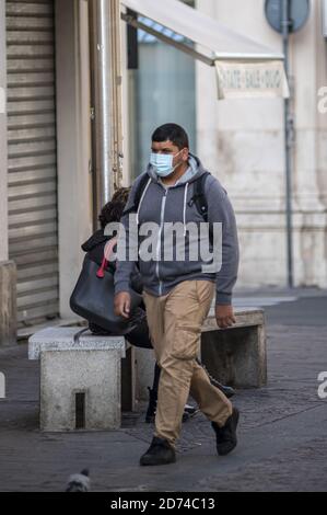 terni,italy october 20 2020:non-EU man with mask walking in the city Stock Photo