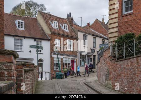People walking on Steep Hill, an ancient medieval street in Lincoln, UK Stock Photo