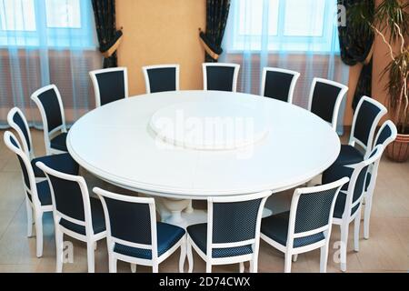 Empty white round conference table and chairs. Diplomatic background. Stock Photo