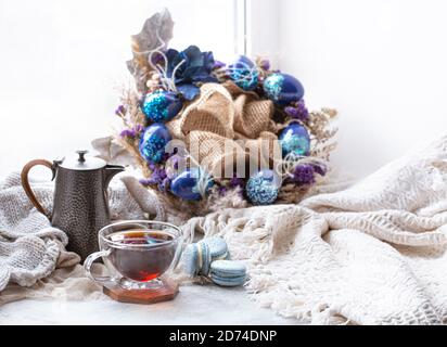Cozy Easter, spring still life scene. Breakfast with tea and dessert macaroons .The concept of the Easter holidays and decor. Stock Photo