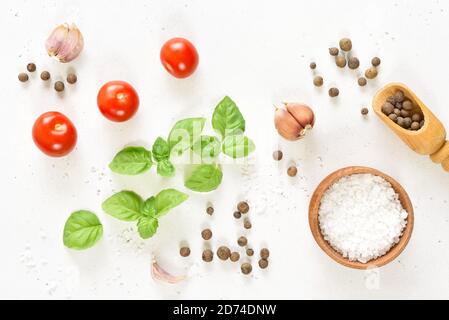 Fresh tomatoes, basil and spices on white stone background. Top view, flat lay Stock Photo