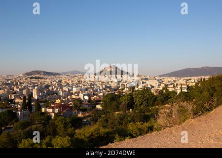 Wide view of Athens Cityscape and Mount Lycabettus at Sunset Scenic view Stock Photo