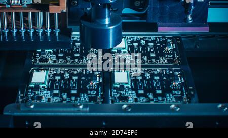 Macro Close-up Shot of Printed Circuit Board on a Factory Assembly Line with Automated Robotic Arm for Surface Mounting Microprocessors to the Stock Photo