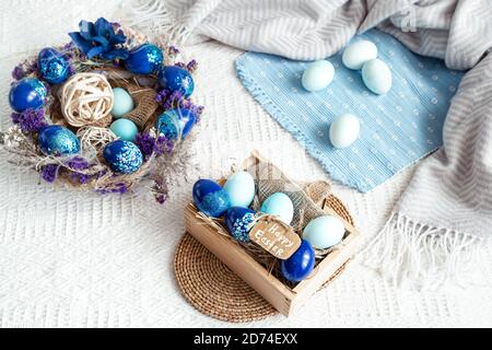 Easter still life with blue eggs, holiday decor . Easter cozy mood. Stock Photo