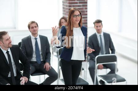 Businesswoman Addressing Delegates At Conference Stock Photo