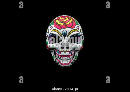 Halloween mask representing a traditional mexican skull with colorful floral pattern isolated on a black background. Stock Photo