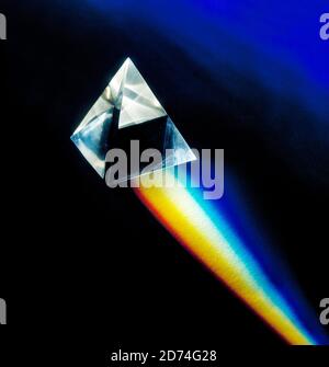 Prism on a black background with refracted white light split into the colours of the spectrum. Stock Photo