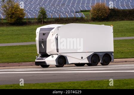 Swedish Einride electric driverless truck, autonomous van, passing solar panels, Top Gear test track, Dunsfold Aerodrome, Surrey, UK Stock Photo