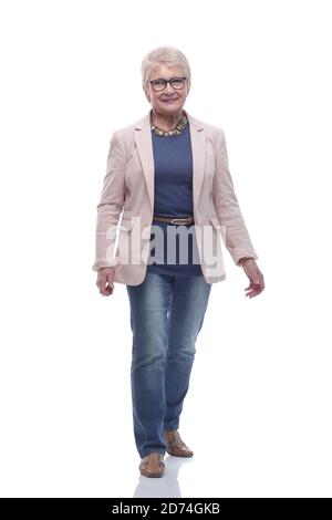 in full growth. smiling senior woman walks forward Stock Photo