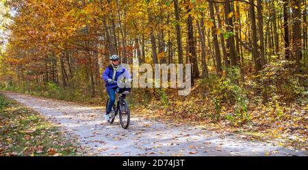 Avoca, Michigan - Susan Newell, 71, bicycles on the Wadhams to Avoca Trail rail trail. The 12-mile trail was created from a former CSX railroad line. Stock Photo