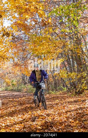 Avoca, Michigan - Susan Newell, 71, bicycles on the Wadhams to Avoca Trail rail trail. The 12-mile trail was created from a former CSX railroad line. Stock Photo