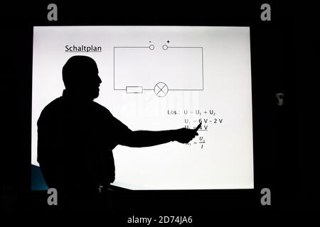 Bannewitz, Germany. 07th Oct, 2020. A teacher is standing at a digital blackboard in a classroom of a secondary school at Marienschacht in Bannewitz near Dresden in Saxony. On the board, tasks for the subject physics are displayed, which pupils have to solve. Credit: Daniel Schäfer/dpa-Zentralbild/ZB/dpa/Alamy Live News Stock Photo