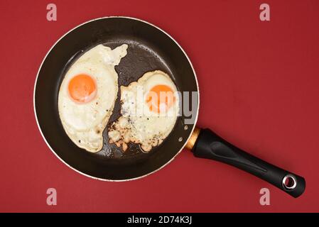 Two fried eggs in a pan Stock Photo