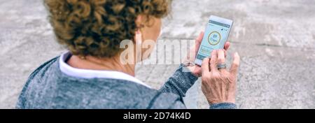 Back view of senior woman using smartphone Stock Photo