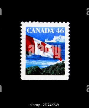 MOSCOW, RUSSIA - NOVEMBER 24, 2017: A stamp printed in Canada shows Canadian Flag and Iceberg, Definitives 1989-2005 serie, circa 1998 Stock Photo