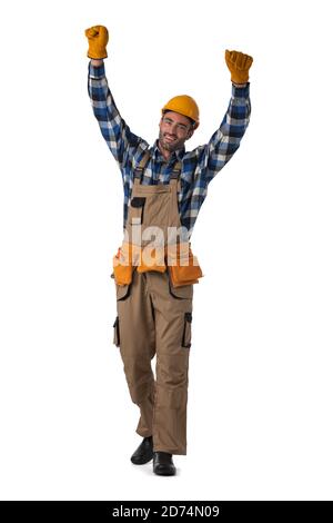 Young contractor worker in coveralls and hardhat with raised arms isolated on white background full length studio portrait Stock Photo