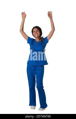Portrait of happy smiling female nurse in blue uniform with raised arms isolated on white background full length studio portrait Stock Photo