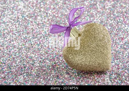 Golden heart with ribbon and sparkling background Stock Photo