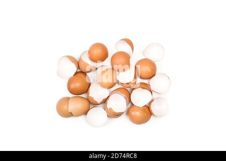 A lot of cracked eggshells on a white background in a top view Stock Photo