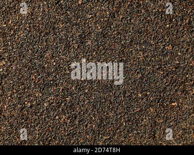 Dried Ceylon black tea leaves background, flat view Stock Photo