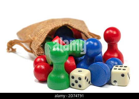 Colorful play figures and dice in a jute bag Stock Photo
