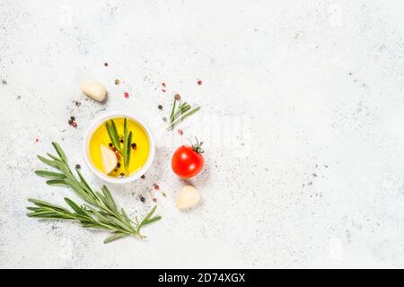 Herbs, spices and vegetables at white kitchen table. Stock Photo