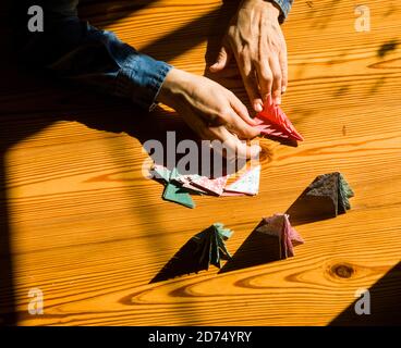 Creating christmas gifts decorations with christmas trees. Made with your own hands. Top view of wooden table with female hands. Leisure crafts for wo Stock Photo