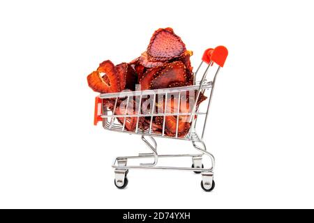 Dehydrated sliced strawberries in a miniature shopping cart isolated on white Stock Photo