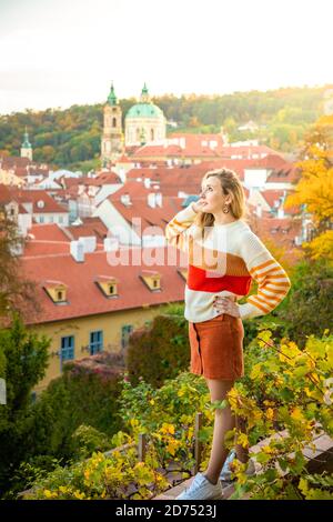 Young woman on red roof background in old town of Prague, Czech republic Stock Photo