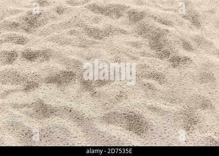 Sand background texture after rain. Wet Sandy beach Stock Photo
