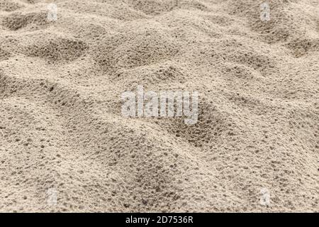 Sand background texture after rain. Wet Sandy beach Stock Photo