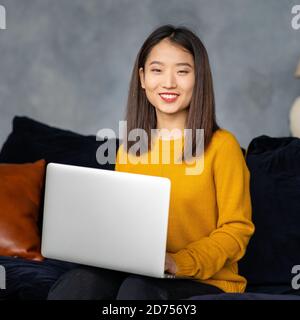 Asian business woman working in laptop on sofa. Japanese businesswoman work at home Stock Photo