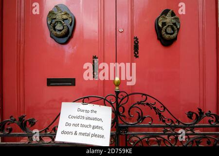 Covid19 warning on an old door in Imdina Malta. Stock Photo