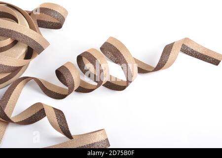 Brown beige Cotton ribbon, strapping tape with curl on white backgroud. Use for sewing clothes, bags. Space for text. Stock Photo