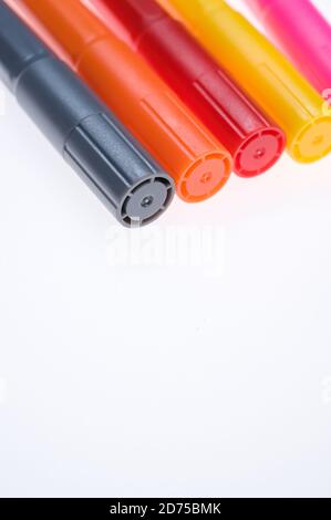 Closeup of five different color markers placed next to each other isolated on a white background Stock Photo