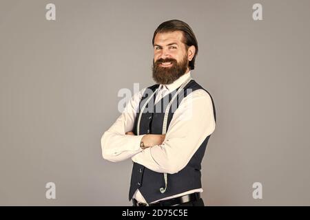 in good mood. brutal man is fashion designer. man designing wardrobe for men. successful sartor ready to work. formal and office style. man tailor with tape measure. man tailoring male clothes. Stock Photo