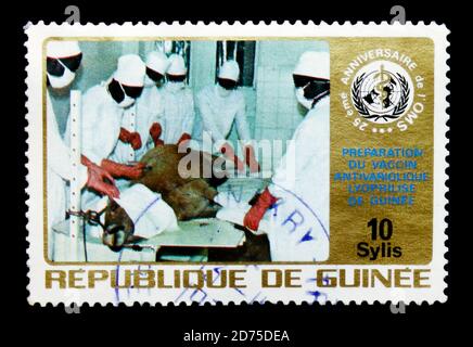 MOSCOW, RUSSIA - JANUARY 2, 2018: A stamp printed in Guinea shows Medical team in vaccinating, World Health Organization, 25th Anniversary serie, circ Stock Photo