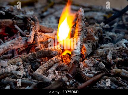 Hot coals and little flames in a dying fire Stock Photo