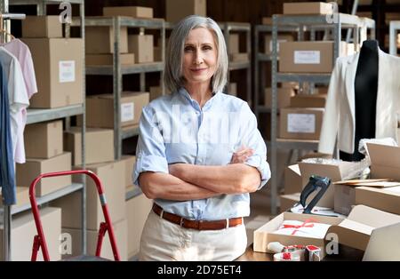 Female entrepreneur clothing store business owner in warehouse, portrait. Stock Photo